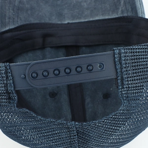 Detail of washed baseball cap showing breathable mesh back and adjustable snap closure
