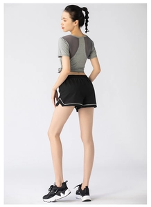 Women's activewear set with mesh back t-shirt and loose shorts seen from side view