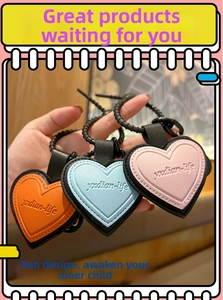 Detailed view of colorful leather heart pendants in orange, blue, and pink styles