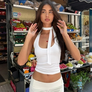 Detail of white halter neck top with choker tie design and ribbed knit fabric