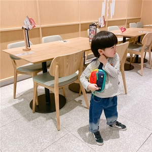 Detail of cute car-shaped colorful shoulder bag for toddlers with adjustable strap