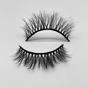 Close-up detail of soft black faux mink false eyelashes with a natural curl and thick texture