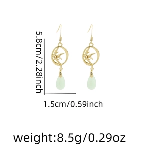 Detail view of bamboo leaf hoop earrings with size specs 5.8cm length and 1.5cm width