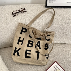 Detail of artistic black letter printing on high-quality beige canvas tote bag material