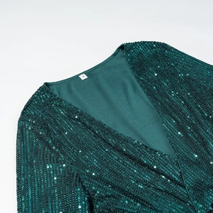 Macro view of V-neckline and intricate green sequins on slim fit evening dress