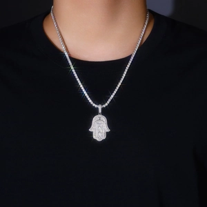 Detailed close-up of a silver-toned Hamsa Hand pendant featuring micro-pave cubic zirconia
