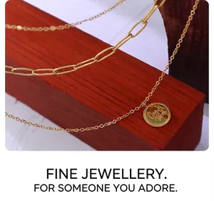 Detail of gold double-layer chain necklace featuring Carpe Diem engraved coin pendant