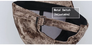 Detail view of adjustable metal buckle and suede fabric texture on baseball cap
