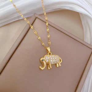 Elegant gold elephant necklace with sparkling crystals on a silk display