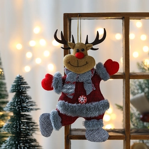 Christmas reindeer ornament in red, grey, and brown hanging on a rustic wooden shelf