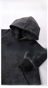 Detail view of the drawstring hood and ribbed cuffs on a dark tie-dye hoodie sweatshirt