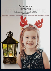 Detail of vintage bronze Christmas lantern with snowman scene and glowing LED light
