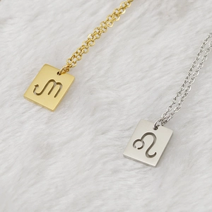 Gold and silver stainless steel zodiac necklaces with rectangular hollow pendants on fur