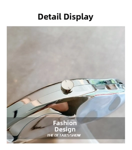 Detail view of the silver metallic clutch side with a round snap closure and mirror finish