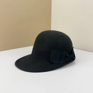 Detailed view of black wool equestrian hat featuring a grosgrain ribbon and side bow accent