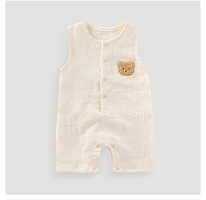 Detail of baby cotton gauze romper with cute plush bear patch and invisible snap buttons
