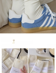 Detail of off-white ribbed cotton socks with decorative buttons and brand packaging