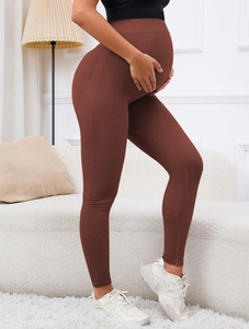 Detail of high-waisted maternity yoga pants with mesh texture and belly support