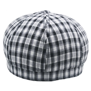 Detailed view of the black and white plaid pattern and stitching on a cotton newsboy hat
