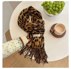Detail of pashmina scarf with leopard print, tassel edges, and 100% cashmere label