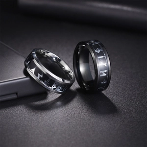Macro shot of silver and black Celtic knot steel rings with engraved Nordic runes