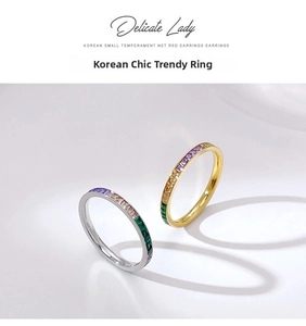Detail showing two colorful zircon stacking rings in gold and silver finish