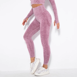Detail of high-waisted seamless leggings and long sleeve crop top with acid wash texture