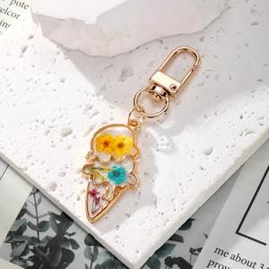 Floral ice cream keychain with real dried flowers in transparent resin and gold metal frame