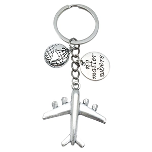 Silver travel keychain with globe, airplane charms and 'no matter where' engraving
