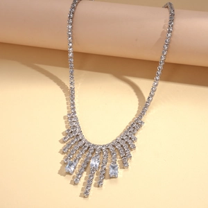 Detail of silver tassel sweater necklace with emerald cut cubic zirconia and rhinestones