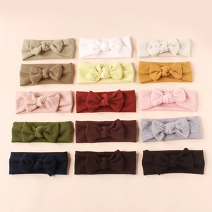 Set of 15 colorful ribbed knit baby headbands with soft knotted bows in various trendy colors