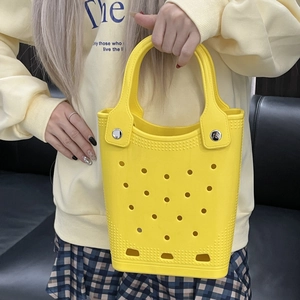 Detail of yellow waterproof EVA beach tote bag featuring a textured perforated design