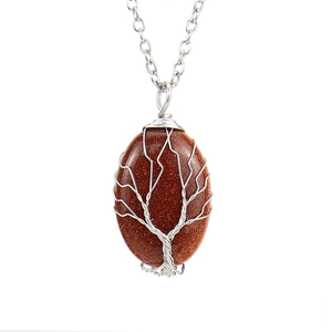 Detailed view of handmade tree of life wire-wrapped oval brown goldstone pendant necklace