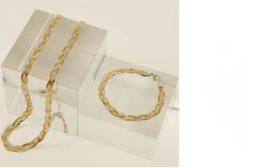 Detailed view of woven herringbone blade chain set in gold, silver, and rose gold finishes