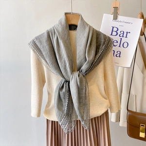 Elegant grey linen cotton lace scarf draped on a model for a chic summer fashion look