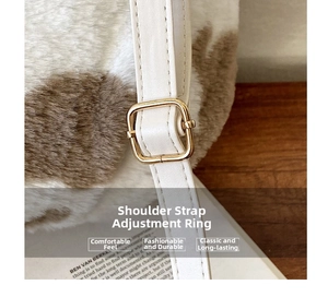 Close-up of cow print faux fur texture with white leather strap and gold buckle
