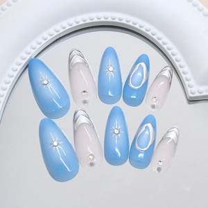 Starry silver glitter press-on nails with blue accents and sparkling crystal rhinestones
