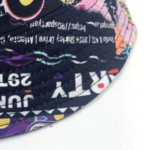 Detailed macro view of retro graffiti pattern and stitching on a black bucket hat