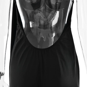 Detail view of a sexy black backless dress featuring a deep V-cut and sleek fabric