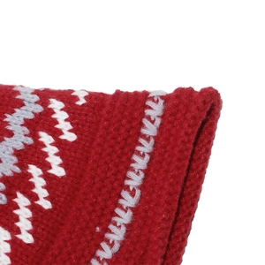 Macro shot of red Fair Isle knit hat with geometric wavy patterns and thick wool texture