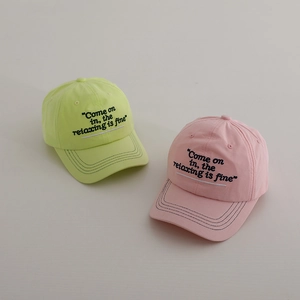 Detailed embroidery on candy-colored cotton baseball caps in mint green and soft pink