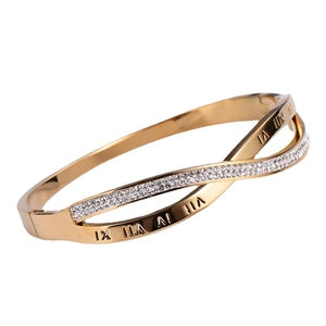 Minimalist gold roman numeral bangle with crossed rings and sparkling zircon stones