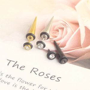Detail of stainless steel spike stud earrings with crystals in gold, silver, and black