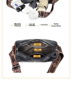 Detail view of the black cylinder bag's interior storage and stylish woven shoulder strap