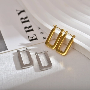Detail of square geometric earrings in gold and silver finish with french lever back