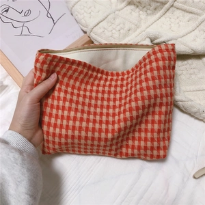 Detailed internal view of red houndstooth cotton makeup bag with metal zipper