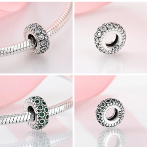 Macro shot of S925 sterling silver beads with clear and green pave-set cubic zirconia