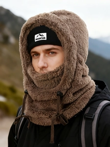 Close-up of brown plush balaclava with mountain tag and black knit beanie set