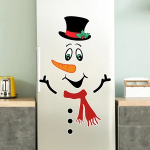 Macro detail of magnetic snowman decals on silver fridge with festive hat and red scarf