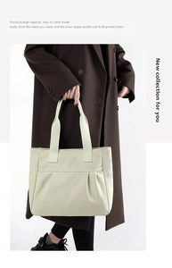 Detail of canvas tote bag with front pocket and large capacity shown on a model